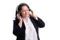 Businesswoman relaxing listening to music touching headphones Royalty Free Stock Photo