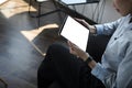 Businesswoman resting on chair in office and using digital tablet. Royalty Free Stock Photo