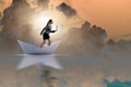 The businesswoman riding paper boat ship in business concept