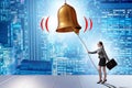 Businesswoman ringing the bell in case of danger