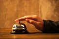 Businesswoman ringing hotel reception bell