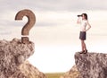 Businesswoman on rock mountain with a question mark Royalty Free Stock Photo