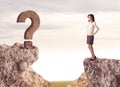 Businesswoman on rock mountain with a question mark Royalty Free Stock Photo