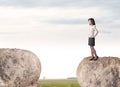 Businesswoman on rock mountain