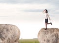 Businesswoman on rock mountain