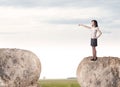 Businesswoman on rock mountain