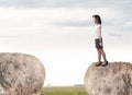 Businesswoman on rock mountain