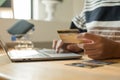 The businesswoman`s hand is holding a credit card and using a laptop for online shopping and internet payment Royalty Free Stock Photo