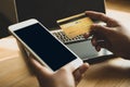 The businesswoman`s hand is holding a credit card and using a smartphone for online shopping and internet payment Royalty Free Stock Photo