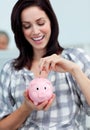 Businesswoman saving money in a piggy-bank Royalty Free Stock Photo