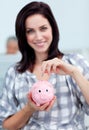 Businesswoman saving money in a piggy-bank Royalty Free Stock Photo