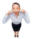 Businesswoman screaming with closed ears