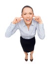 Businesswoman screaming with closed ears