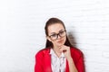 Businesswoman serious wear red jacket glasses hold chin ponder Royalty Free Stock Photo
