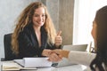 Businesswoman shaking hands with supplier and thumb up for good offer deal