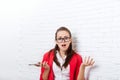 Businesswoman shocked hold cell smart phone wear red jacket glasses stressed problem gesture