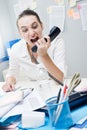 Businesswoman shouting at phone