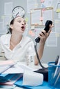 Businesswoman shouting at phone