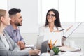 Businesswoman showing good statistics report at meeting