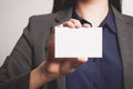 Businesswoman showing and handing a blank business card.