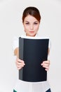 Businesswoman showing her report in black folder