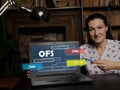 Businesswoman showing laptop with acronym OFS Offer For Sale on the screen