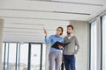 Businesswoman showing new office building interior to businessman Royalty Free Stock Photo