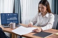 Businesswoman signing contract document with pen. Enthusiastic.