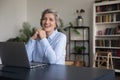 Businesswoman sit at desk with laptop smile staring at camera