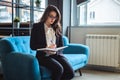 Businesswoman siting in the office resting area and writing Royalty Free Stock Photo