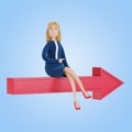 The businesswoman sits on the arrow and shows the right direction. Royalty Free Stock Photo