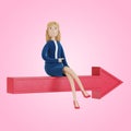 The businesswoman sits on the arrow and shows the right direction.