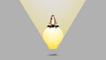 A businesswoman sits on a big light bulb