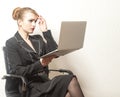 Businesswoman sits on chair and work on laptop