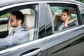Businesswoman sitting on back seat in taxi car, talking on the phone. Royalty Free Stock Photo