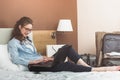 Businesswoman working in hotel room, using laptop. Royalty Free Stock Photo