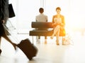 Businesswoman sitting on bench and reading newspaper in airport Royalty Free Stock Photo