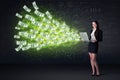 Businesswoman sitting in chair holding laptop with dollar bills Royalty Free Stock Photo