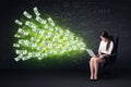 Businesswoman sitting in chair holding laptop with dollar bills Royalty Free Stock Photo