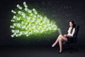 Businesswoman sitting in chair holding laptop with dollar bills Royalty Free Stock Photo