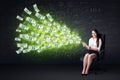 Businesswoman sitting in chair holding tablet with dollar bills Royalty Free Stock Photo