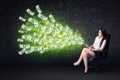 Businesswoman sitting in chair holding tablet with dollar bills Royalty Free Stock Photo