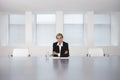 Businesswoman Sitting At Conference Table Royalty Free Stock Photo