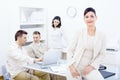 Businesswoman sitting on desk