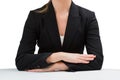 Businesswoman sitting at desk with arms crossed Royalty Free Stock Photo