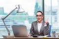 The businesswoman sitting at her desk in business concept Royalty Free Stock Photo