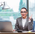 Businesswoman sitting at her desk in business concept Royalty Free Stock Photo