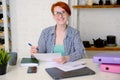 Businesswoman is sitting at her desk and sorting out official documents Royalty Free Stock Photo