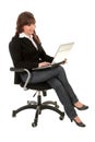 Businesswoman sitting in office chair with laptop Royalty Free Stock Photo