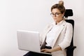 Businesswoman sitting on the office chair and using laptop pc Royalty Free Stock Photo